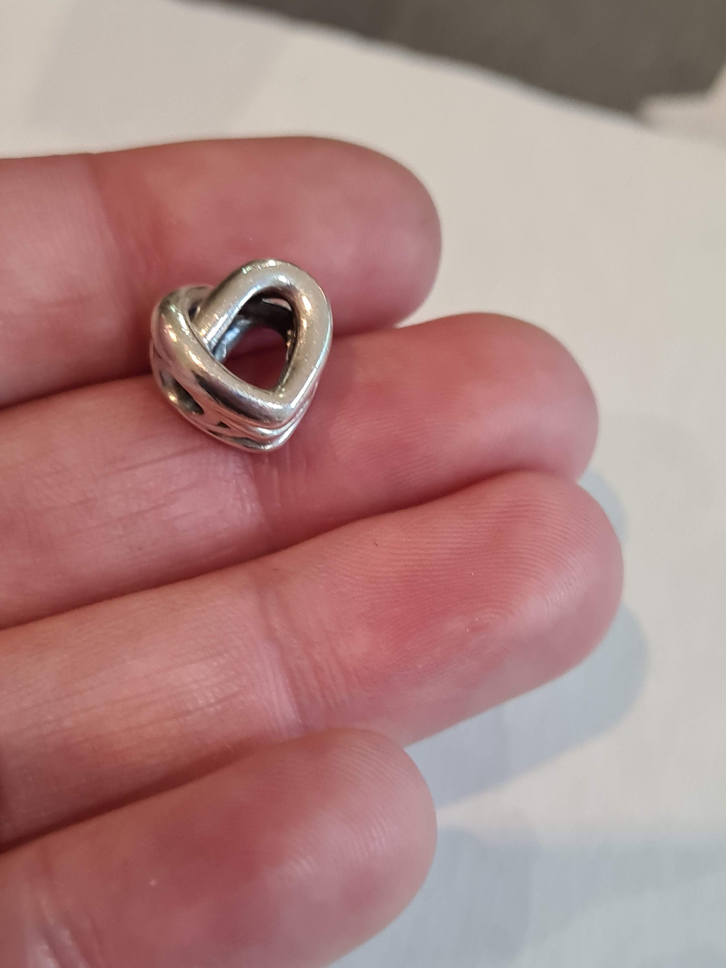 Genuine Pandora Beautiful Openwork Heart Twist Charm.
