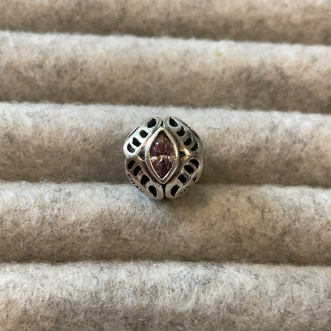 Genuine Chamilia open work charm with purple stone